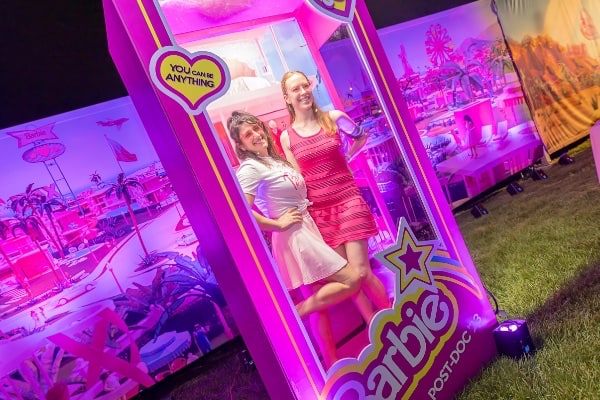 Two girls inside a lifesize Barbie box